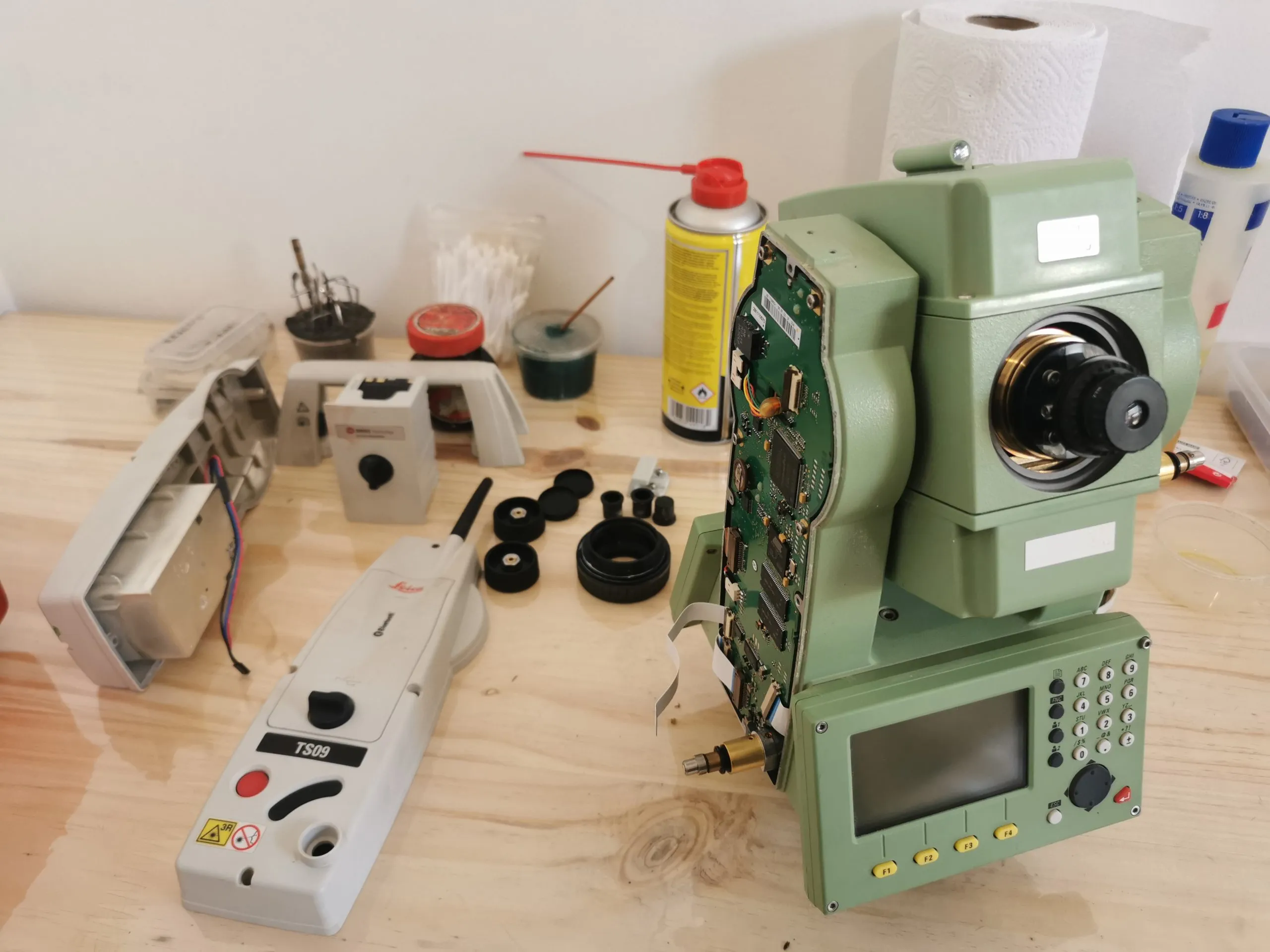 A Leica total station opened up on the GeoSurv Africa service bench