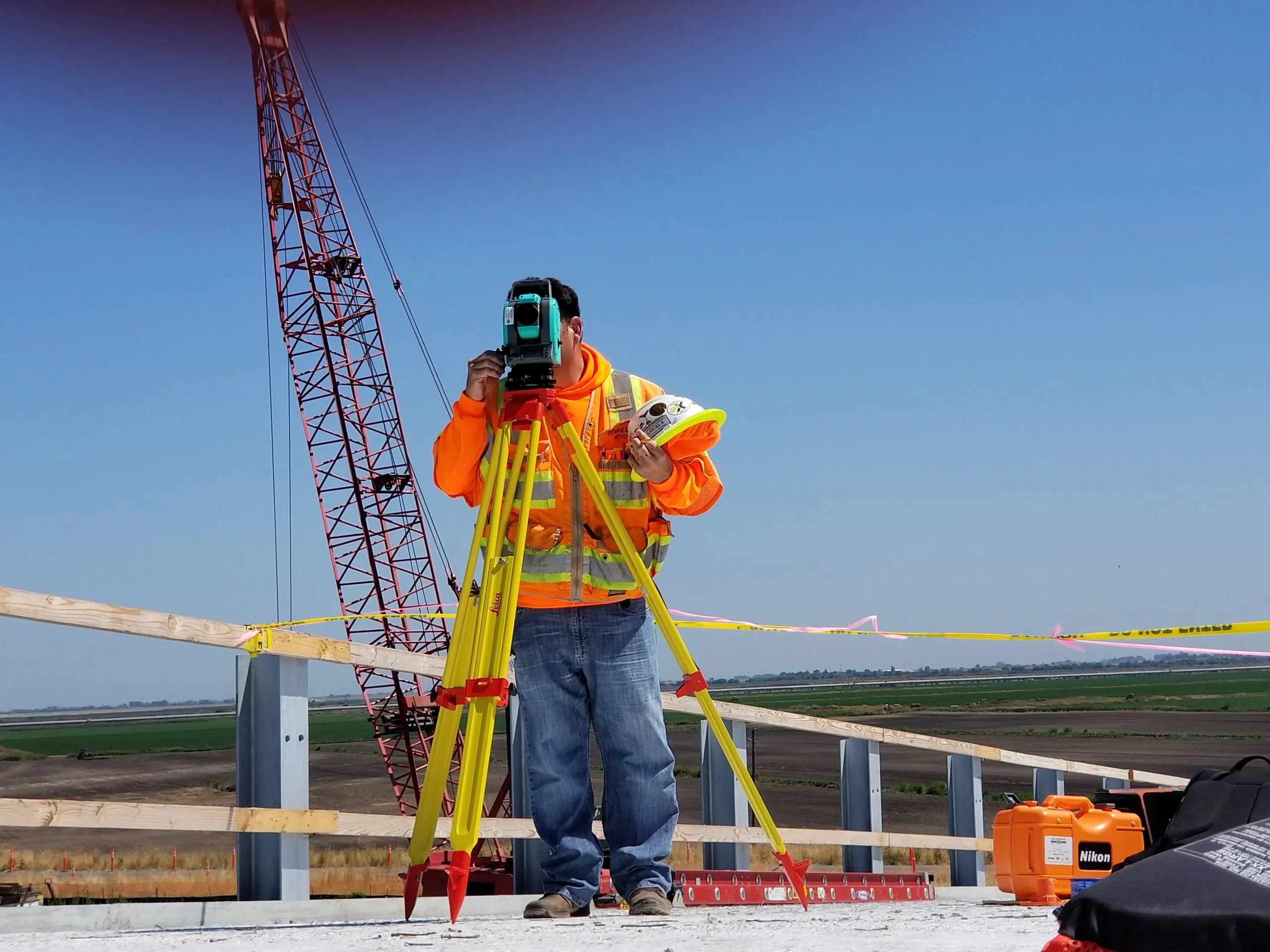 A surveyor setting out with a total station on a construction site